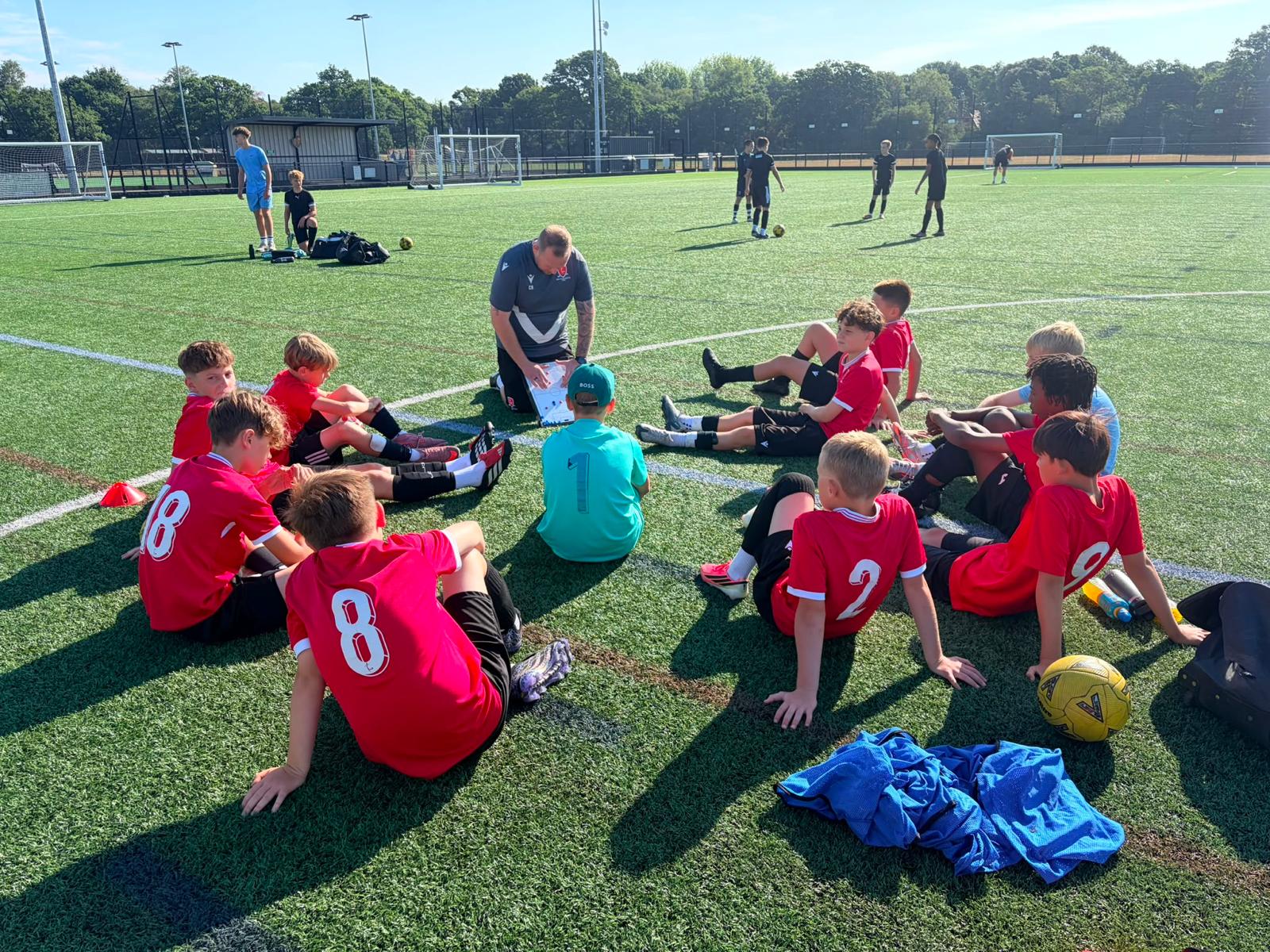 BRS coach speaking with young players during a development-centre session