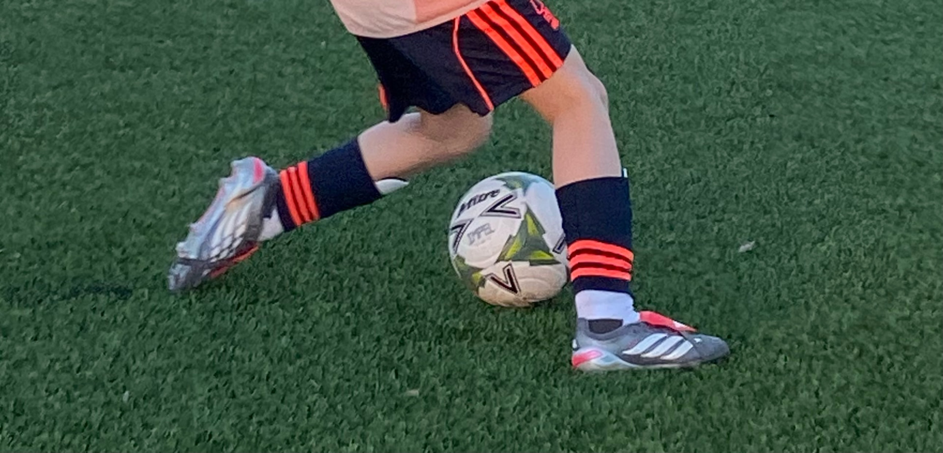 Young BRS player practising close control with a football